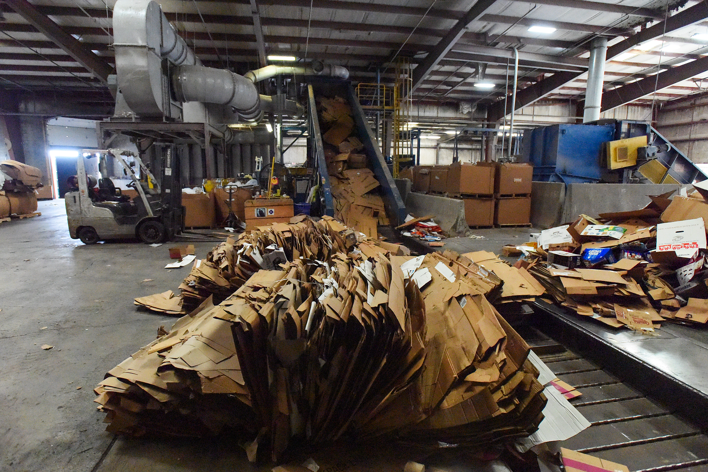 A piece of cardboard is placed at the end of Diamond's baler...