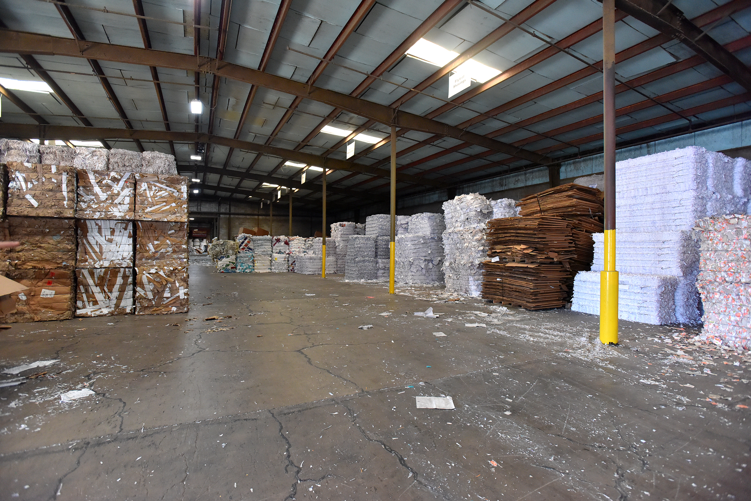 Bundles of cardboard and paper products line the store.