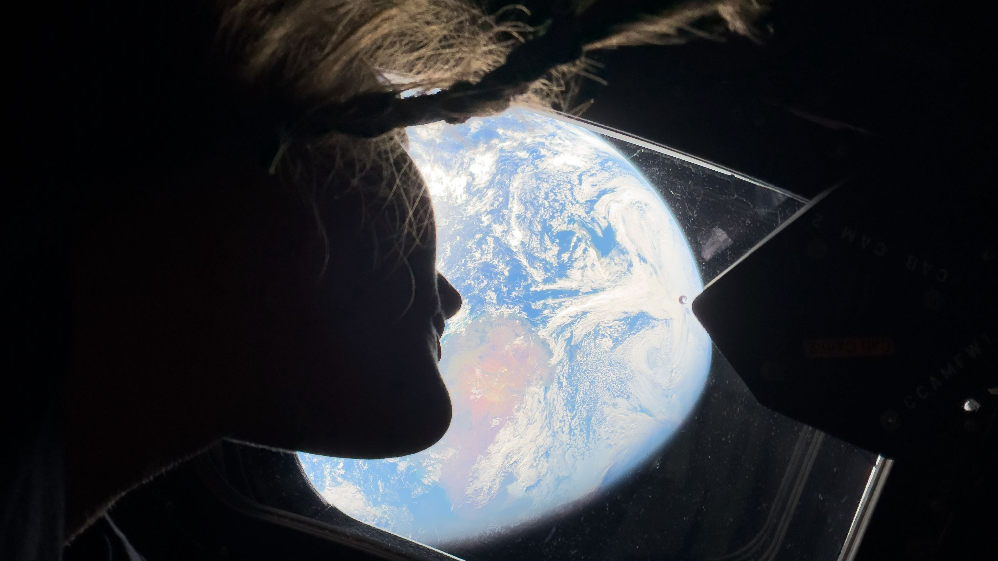 NASA's Artemis 2 astronaut Christina Koch looks at Earth as the Orion spacecraft heads to the moon in April 2026.