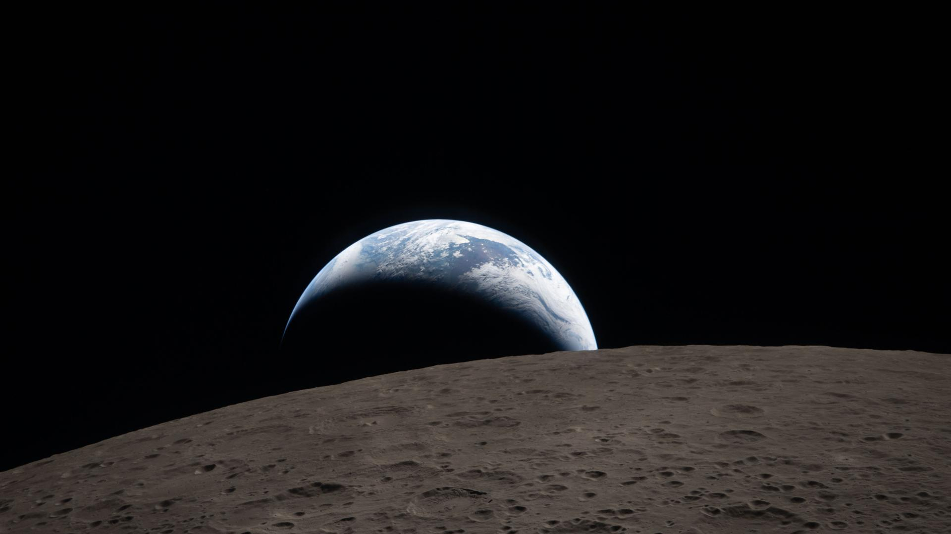 Earth set photographed through the window of the Orion spacecraft during the Artemis 2 crew's lunar flight on April 6, 2026 at 6:41 p.m. EDT