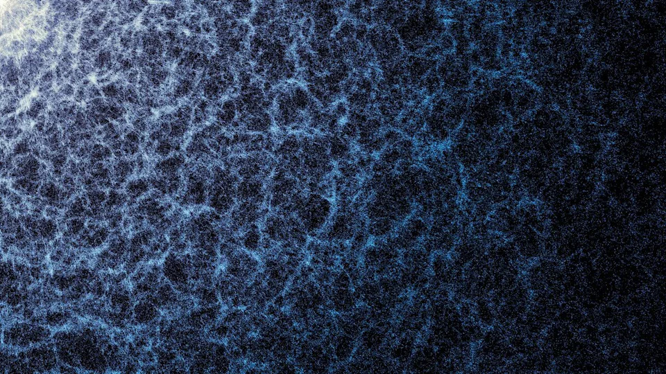 Blue and white map on a dark background. Dense regions indicate areas where galaxies and galaxy clusters are clumping together to form threads of the cosmic web. .